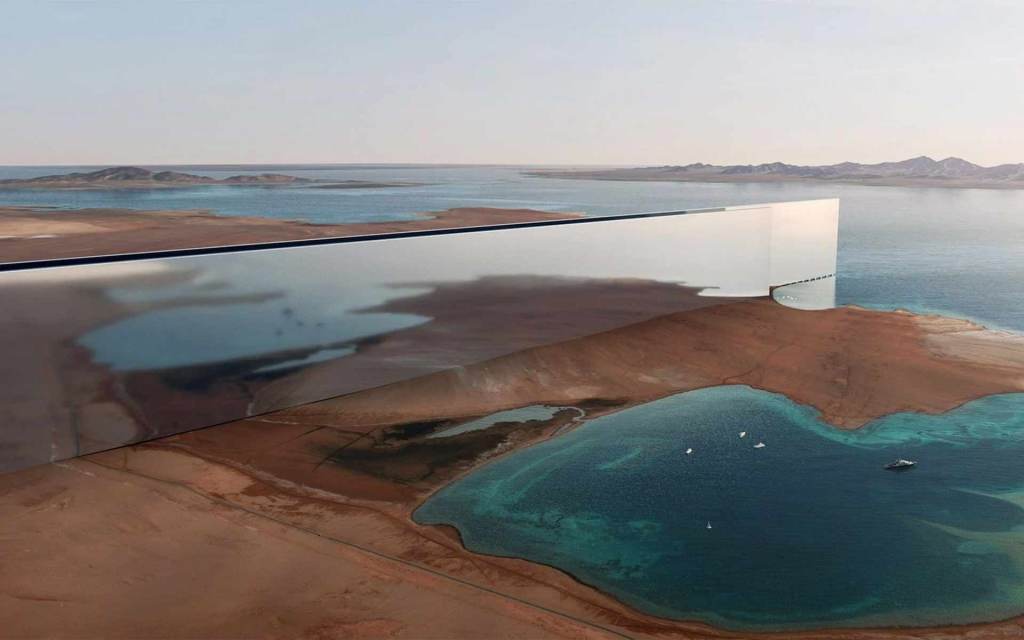 Aerial view of the construction site for 'The Line,' showcasing its reflective skyscraper design in the desert near the coast of Saudi Arabia.